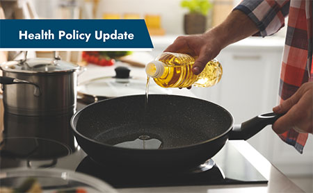 Person pouring oil into a frying pan in a kitchen with a banner in the upper left that says, "Health Policy Update."